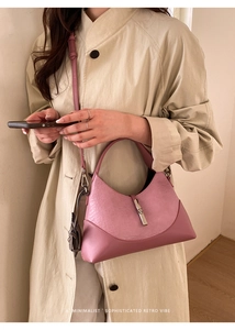 Detail showing pink faux crocodile hobo bag with silver buckle and smooth matte paneling