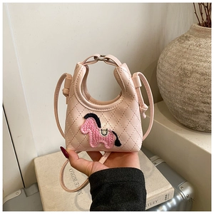 Detailed macro view of pink quilted mini bag featuring cute horse embroidery and handle
