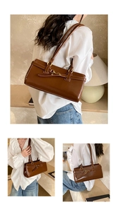 Detailed close-up of dark brown baguette bag with golden horsebit buckle and slim straps