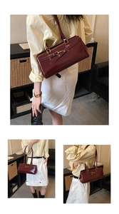 Detailed view of vintage burgundy handbag with glossy finish and gold horsebit hardware
