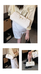 Detail view of a white vintage faux leather shoulder bag with gold metal buckle accents