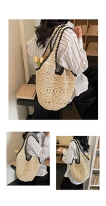 Detail of hollow woven straw tote bag with black trim and vintage French style texture