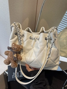 White quilted drawstring bucket bag with chain strap and cute teddy bear charm