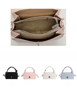 Detail of multi-color small square bags with interior zip pocket and metal twist lock