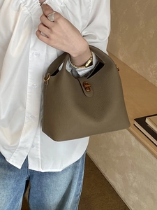Khaki leather bucket bag with top handle and gold clasp for elegant commute styling