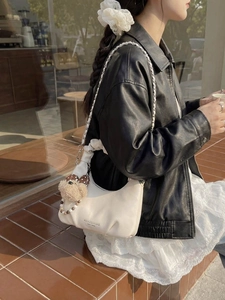 White pleated moon bag with metal chain strap and cute puppy pendant accessory