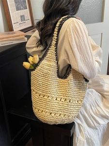 Handmade straw tote bag with black trim and hollow decorative stripes for beach vacation