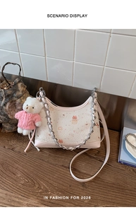 Detail der rosa bedruckten Umhängetasche mit Silberkette und süßem Teddybär-Anhänger