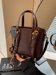 Retro dark brown leather bucket bag with top handles and gold hardware details