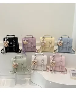 Detailed close-up of mini flap backpacks in seven colors with cute bear charms