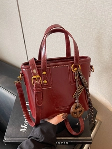 Vintage burgundy glossy leather bucket bag with top handles and adjustable shoulder strap