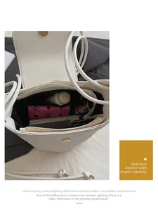 Top view of white lychee leather bucket bag showing interior space with magnet closure