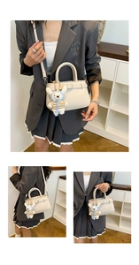 Chic beige lychee leather tote bag with cute bear charm and adjustable shoulder strap