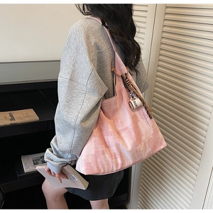 Detail of pink abstract tote bag with a coffee cup charm and canvas texture on a wide strap