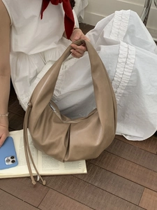Pleated khaki hobo tote bag featuring a cloud-shaped design and side strap details