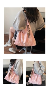 Detail of pink patchwork tote bag featuring a decorative coffee cup pendant and woven strap