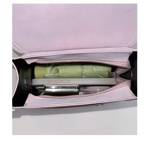 Top view of lavender leather crossbody bag showing inner storage for phone and umbrella