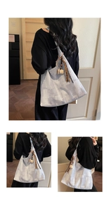 Detailed view of blue denim texture tote bag with leather tassel and coffee cup charm