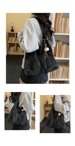 Detail of black geometric texture tote bag with coffee cup charm in library setting