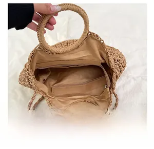 Détail du sac en paille tressée kaki montrant la doublure et la poche zippée