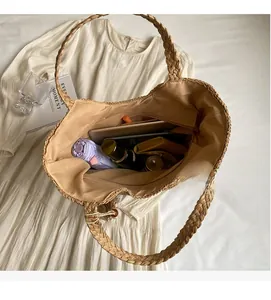 Top view of a woven straw tote bag interior showing large capacity and zipper pocket