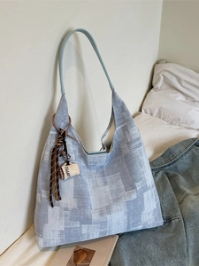 Minimalist canvas tote bag in light blue with stylish coffee pendant and slim straps