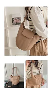 Detailed views of a khaki lychee pattern leather bucket bag with top stitching