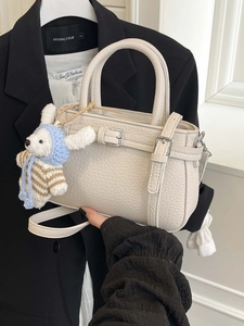 Minimalist white leather handbag with rabbit pendant and detachable shoulder strap