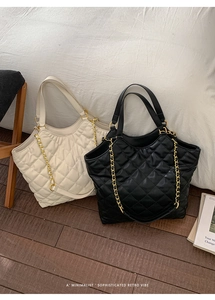 Top view of quilted bucket bags in beige and black with golden chain straps and soft texture
