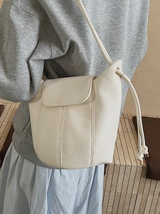 Litchi pattern leather bucket bag in cream white with drawstring and shoulder strap
