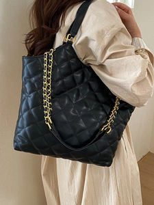 Large black quilted tote bag with golden chain strap for women in spring summer style