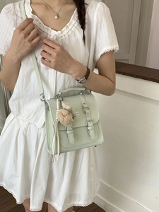 Minimalist mint green crossbody bag with leather texture and cute plush pendant