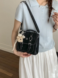 Minimalist black retro messenger bag with contrast stitching and cute bear charm