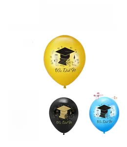 Detail of latex graduation balloons in four colors with We Did It text and icons