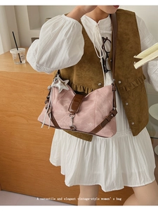 Detail of dusty rose suede shoulder bag featuring silver star charm and long fringes