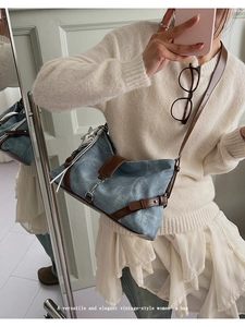 Detail of Morandi blue crossbody bag with vintage leather straps and side fringe tassel