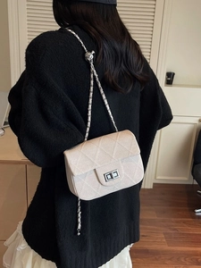 Chic beige quilted square bag with chain strap and silver twist lock for daily style
