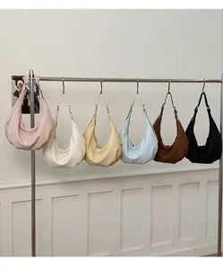 Hobo-Taschen in sechs Farben auf einem Ständer mit glatter minimalistischer Lederoptik