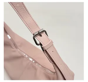 Nahaufnahme der rosa Umhängetasche mit Kieselleder-Textur und verstellbarem Gurt
