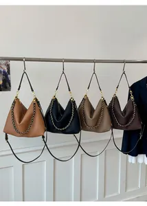 Detail view of large soft leather hobo bags in four colors with gold chain straps