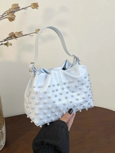 Light blue faux leather handbag with pearl rivet accents and drawstring pleated design