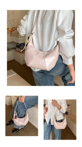 Detail of light pink moon bag featuring contrast stitching and adjustable strap