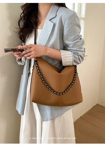 Brown lychee leather tote bag with elegant black and gold woven chain shoulder strap