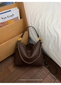 Detail of brown litchi pattern leather Hobo bag with gold chain and metal hardware