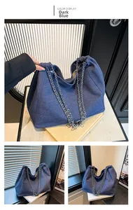 Close-up of dark blue denim tote bag with silver chain straps and large capacity