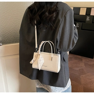 Chic white faux crocodile leather handbag with decorative silk scarf and shoulder strap