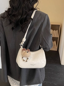 Fashionable cream white half moon hobo shoulder bag with a cute plush bear charm