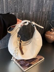 White glossy crescent moon shoulder bag with silver hardware and chic tassel decoration