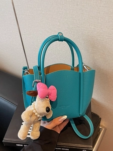 Peacock blue lychee pattern leather tote bag with wavy rim and plush puppy charm