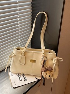 Chic beige faux leather underarm tote bag with a cute teddy bear plush charm